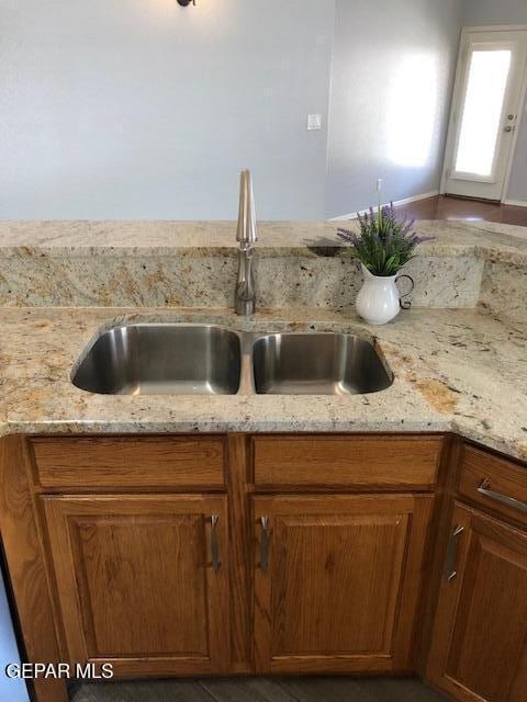 6392 Franklin Gate Dr, El Paso, TX 79912 - kitchen view of light stone counters and brown cabinets