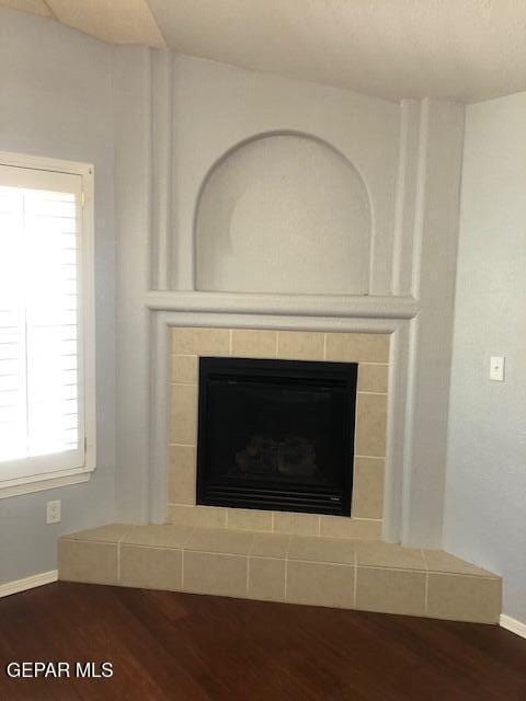 6392 Franklin Gate Dr, El Paso, TX 79912 - detailed view of wood finished floors and a tiled fireplace