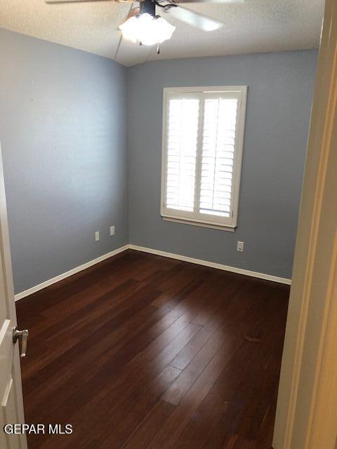 6392 Franklin Gate Dr, El Paso, TX 79912 - spare room with ceiling fan and dark wood-style floors
