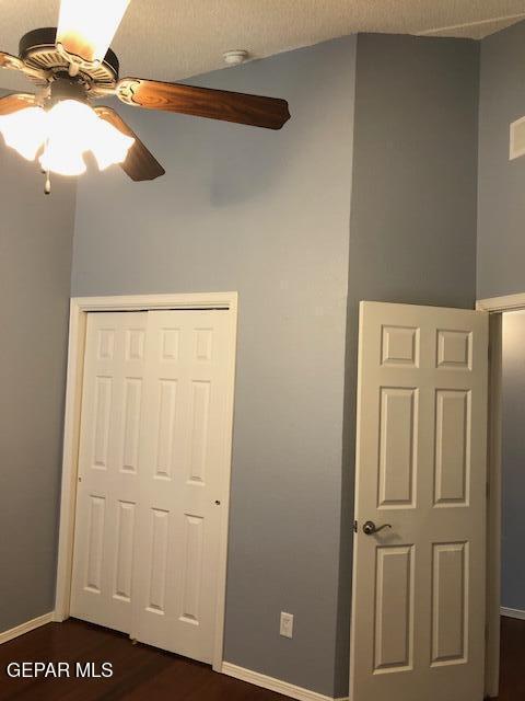 6392 Franklin Gate Dr, El Paso, TX 79912 - unfurnished bedroom with a closet, dark wood-style flooring, and ceiling fan