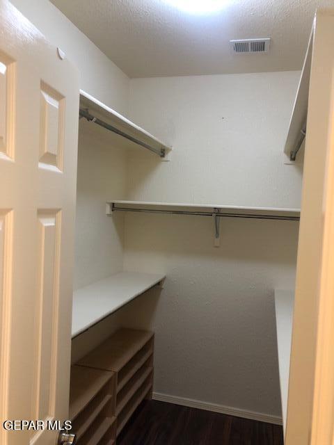 6392 Franklin Gate Dr, El Paso, TX 79912 - walk in closet featuring dark wood-style floors