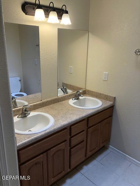 6392 Franklin Gate Dr, El Paso, TX 79912 - bathroom with tile patterned floors and double vanity