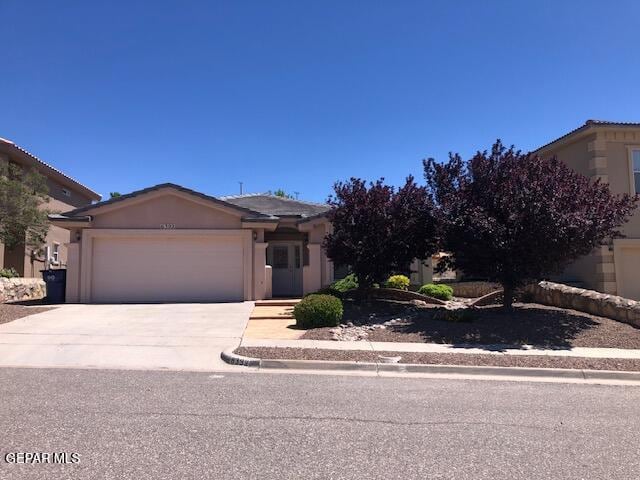 6392 Franklin Gate Dr, El Paso, TX 79912 - view of front of home featuring a garage, concrete driveway, and stucco siding