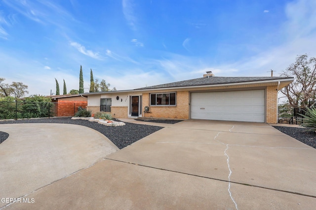 3310 Moonlight Ave, El Paso, TX 79904 - ranch-style home with concrete driveway, brick siding, and a garage
