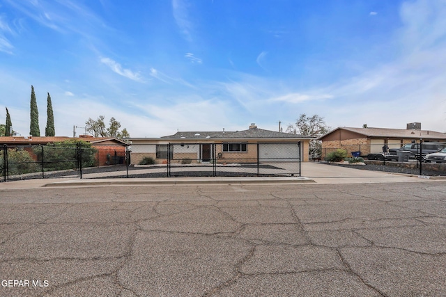 3310 Moonlight Ave, El Paso, TX 79904 - view of front of house featuring a fenced front yard, concrete driveway, and an attached garage