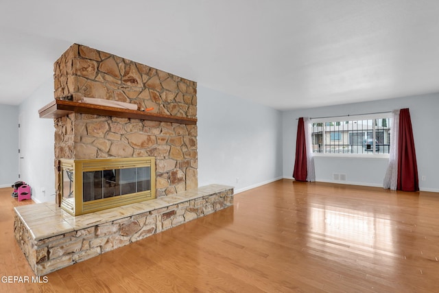 3310 Moonlight Ave, El Paso, TX 79904 - unfurnished living room with wood finished floors and a fireplace