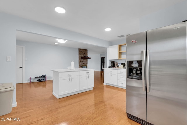 3310 Moonlight Ave, El Paso, TX 79904 - kitchen featuring stainless steel fridge, white cabinets, light wood-type flooring, open shelves, and light countertops