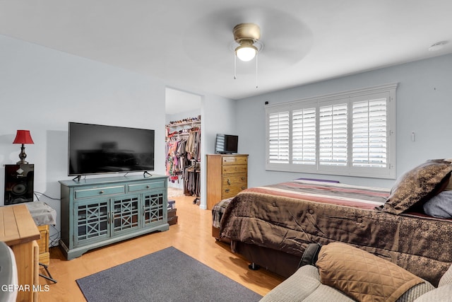 3310 Moonlight Ave, El Paso, TX 79904 - bedroom featuring wood finished floors, a walk in closet, a closet, and a ceiling fan