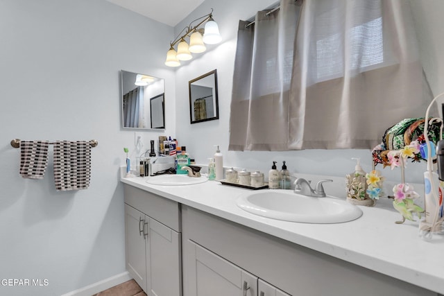 3310 Moonlight Ave, El Paso, TX 79904 - full bath featuring double vanity and baseboards