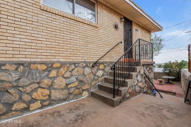 3310 Moonlight Ave, El Paso, TX 79904 - doorway to property with a patio and brick siding