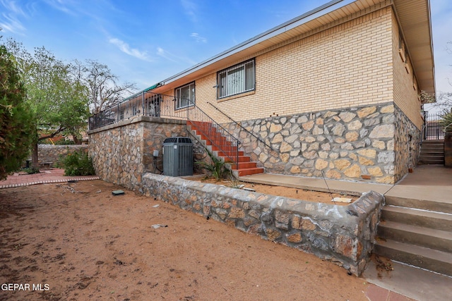 3310 Moonlight Ave, El Paso, TX 79904 - rear view of house with stairway, brick siding, and stone siding