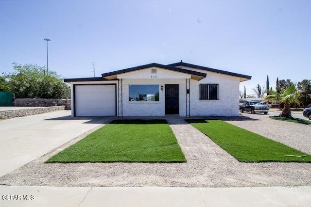 8141 Callison Rd, El Paso, TX 79907 - view of front facade featuring an attached garage, concrete driveway, a front yard, and brick siding