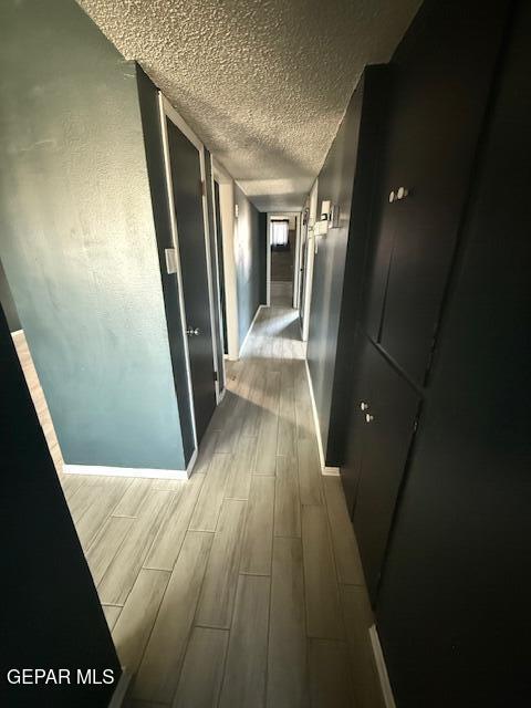 8141 Callison Rd, El Paso, TX 79907 - hall featuring wood finish floors and a textured ceiling