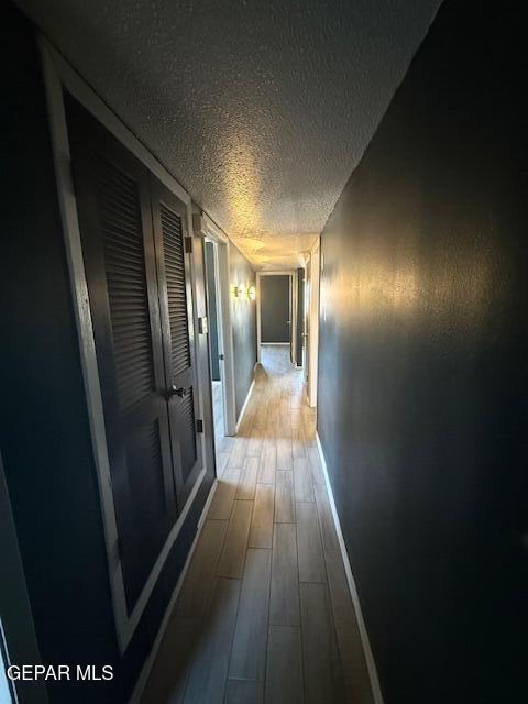 8141 Callison Rd, El Paso, TX 79907 - corridor featuring a textured ceiling and wood finished floors