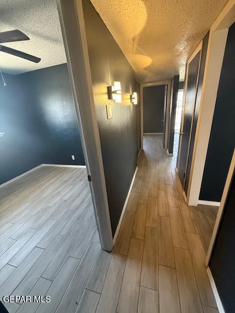 8141 Callison Rd, El Paso, TX 79907 - hallway featuring a textured ceiling and wood finished floors