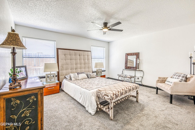 3485 Running Deer Dr, El Paso, TX 79936 - carpeted bedroom featuring multiple windows, a textured ceiling, and ceiling fan