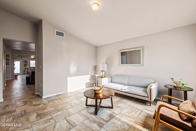 11625 Flor Clavel St, El Paso, TX 79927 - living area featuring vaulted ceiling and light stone finish floors