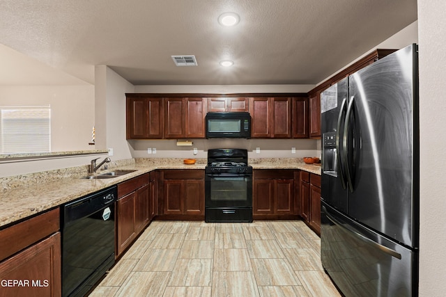 11625 Flor Clavel St, El Paso, TX 79927 - kitchen with black appliances, light stone countertops, and recessed lighting