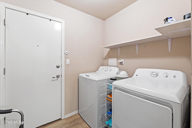 11625 Flor Clavel St, El Paso, TX 79927 - laundry area featuring washer and clothes dryer and light wood finished floors