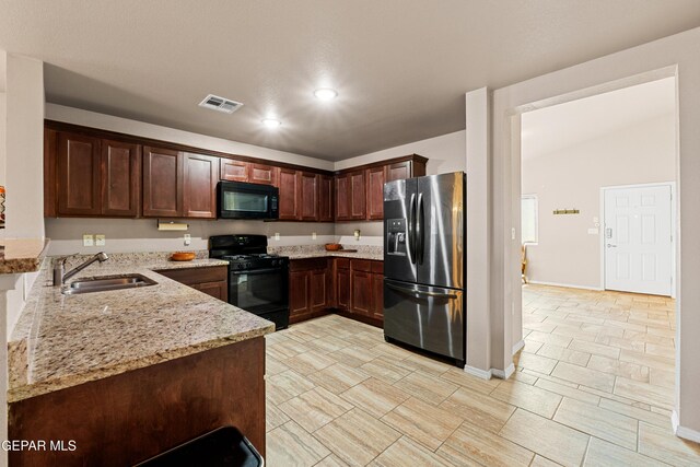 11625 Flor Clavel St, El Paso, TX 79927 - kitchen featuring black appliances, light stone counters, dark brown cabinets, and recessed lighting