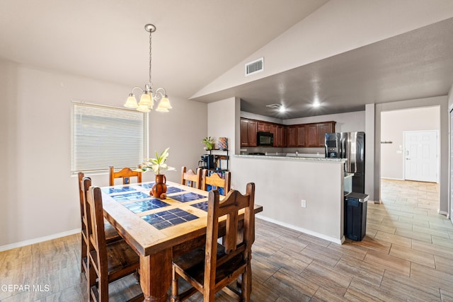 11625 Flor Clavel St, El Paso, TX 79927 - dining room with a chandelier, vaulted ceiling, and wood tiled floors