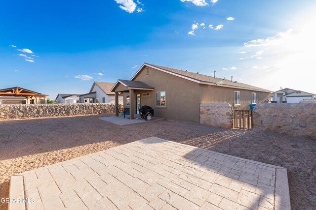 11625 Flor Clavel St, El Paso, TX 79927 - back of property featuring a patio, a gate, and stucco siding