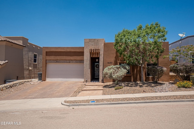 6585 Hermoso Del Sol Dr, El Paso, TX 79911 - pueblo-style house with driveway, an attached garage, and stucco siding