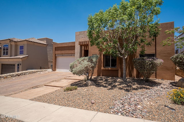 6585 Hermoso Del Sol Dr, El Paso, TX 79911 - southwest-style home with an attached garage, stucco siding, and driveway