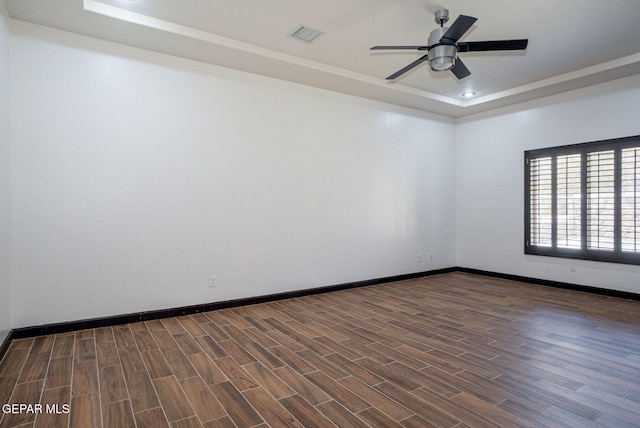 6585 Hermoso Del Sol Dr, El Paso, TX 79911 - unfurnished room with a tray ceiling, dark wood-type flooring, ceiling fan, and recessed lighting