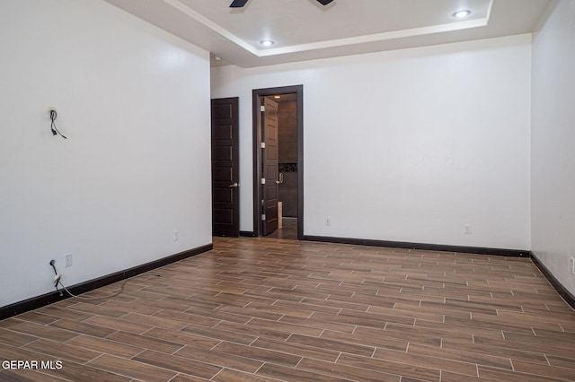 6585 Hermoso Del Sol Dr, El Paso, TX 79911 - empty room featuring wood finished floors, a tray ceiling, a ceiling fan, and recessed lighting