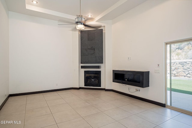 6585 Hermoso Del Sol Dr, El Paso, TX 79911 - unfurnished living room with a glass covered fireplace, a ceiling fan, light tile patterned floors, and recessed lighting