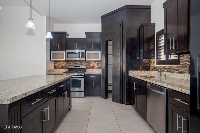 6585 Hermoso Del Sol Dr, El Paso, TX 79911 - kitchen featuring stainless steel appliances, decorative backsplash, light tile patterned floors, and decorative light fixtures