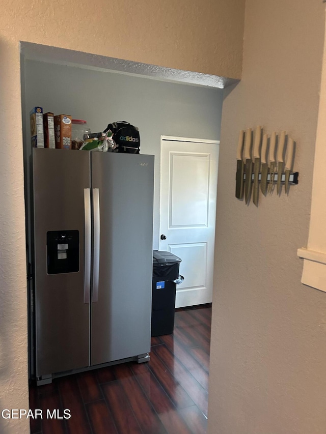 1012 Maple St, El Paso, TX 79903 - kitchen with stainless steel fridge, dark wood finished floors, and a textured wall