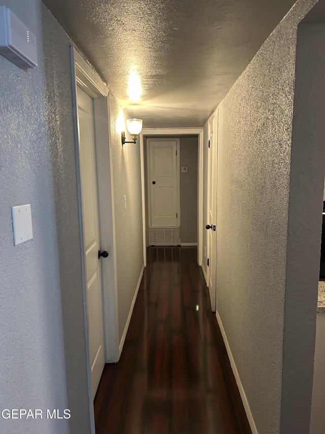 1012 Maple St, El Paso, TX 79903 - corridor featuring a textured wall, wood finished floors, and a textured ceiling