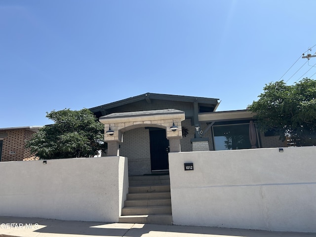 1012 Maple St, El Paso, TX 79903 - view of front of home with a fenced front yard and brick siding