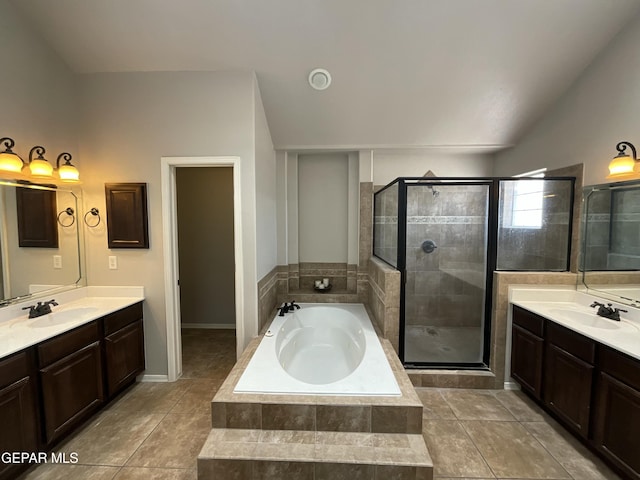 12000 Stansbury Dr, El Paso, TX 79928 - bathroom featuring a bath, a shower stall, two vanities, vaulted ceiling, and tile patterned flooring