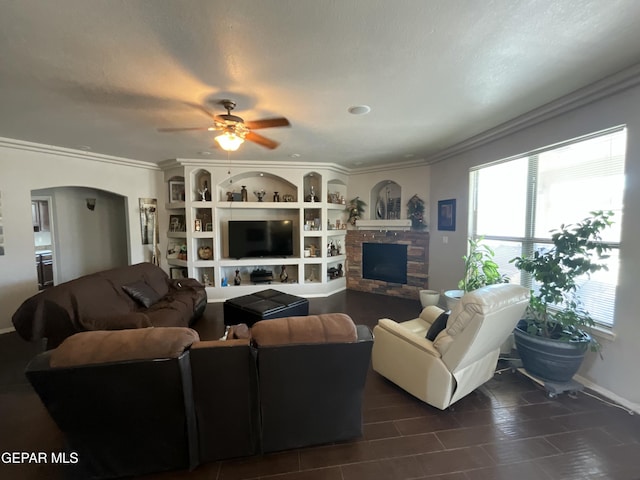 12000 Stansbury Dr, El Paso, TX 79928 - living room featuring arched walkways, ornamental molding, ceiling fan, and a stone fireplace