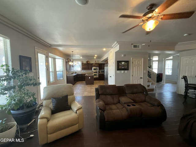 12000 Stansbury Dr, El Paso, TX 79928 - living room featuring healthy amount of natural light, ceiling fan, ornamental molding, stairway, and arched walkways