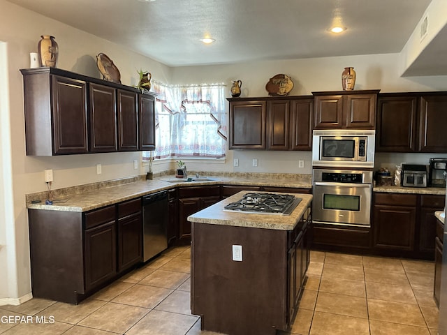 12000 Stansbury Dr, El Paso, TX 79928 - kitchen featuring appliances with stainless steel finishes, dark brown cabinets, light countertops, a center island, and recessed lighting