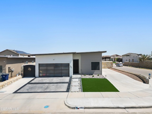 14821 Sunny Land Ave, El Paso, TX 79938 - modern home featuring driveway, a garage, and a gate