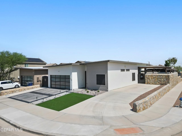 14821 Sunny Land Ave, El Paso, TX 79938 - contemporary house featuring an attached garage, stucco siding, and concrete driveway