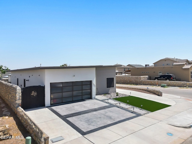 14821 Sunny Land Ave, El Paso, TX 79938 - contemporary house featuring driveway and a garage