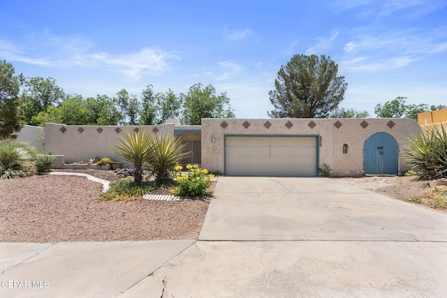 5536 Fernwood Cir, El Paso, TX 79932 - southwest-style home featuring stucco siding, concrete driveway, and an attached garage