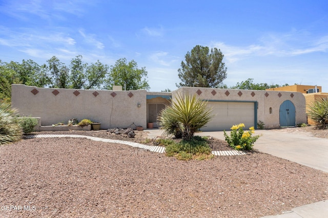 5536 Fernwood Cir, El Paso, TX 79932 - adobe home featuring stucco siding, driveway, and a garage