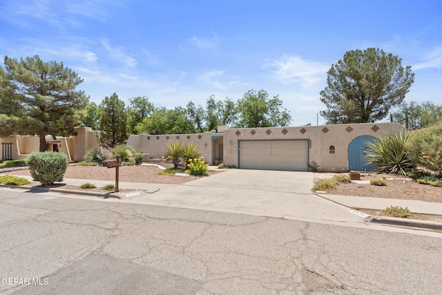 5536 Fernwood Cir, El Paso, TX 79932 - southwest-style home with stucco siding, concrete driveway, and a garage