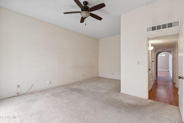 5536 Fernwood Cir, El Paso, TX 79932 - carpeted spare room featuring arched walkways, ceiling fan, and a textured ceiling