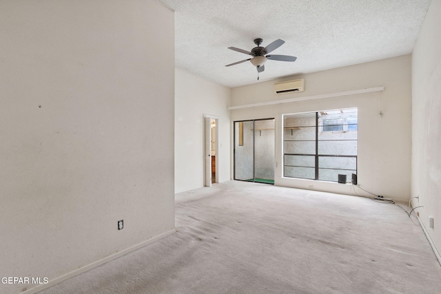 5536 Fernwood Cir, El Paso, TX 79932 - carpeted spare room with ceiling fan, a wall mounted air conditioner, and a textured ceiling