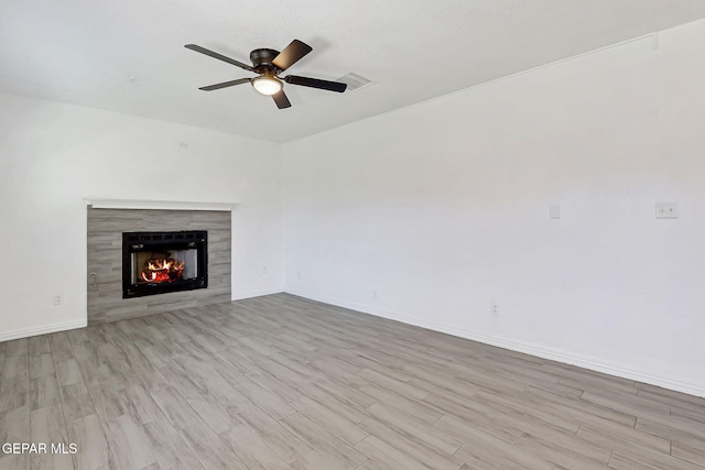 11948 Crown Oaks Ct, El Paso, TX 79936 - unfurnished living room featuring wood finished floors, ceiling fan, and a fireplace