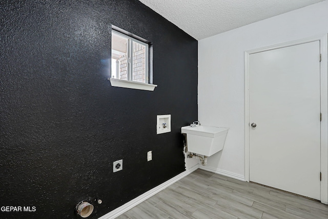11948 Crown Oaks Ct, El Paso, TX 79936 - washroom featuring electric dryer hookup, light wood-style flooring, washer hookup, a textured ceiling, and hookup for a gas dryer