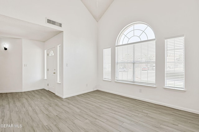 11948 Crown Oaks Ct, El Paso, TX 79936 - spare room with plenty of natural light, wood finished floors, and vaulted ceiling